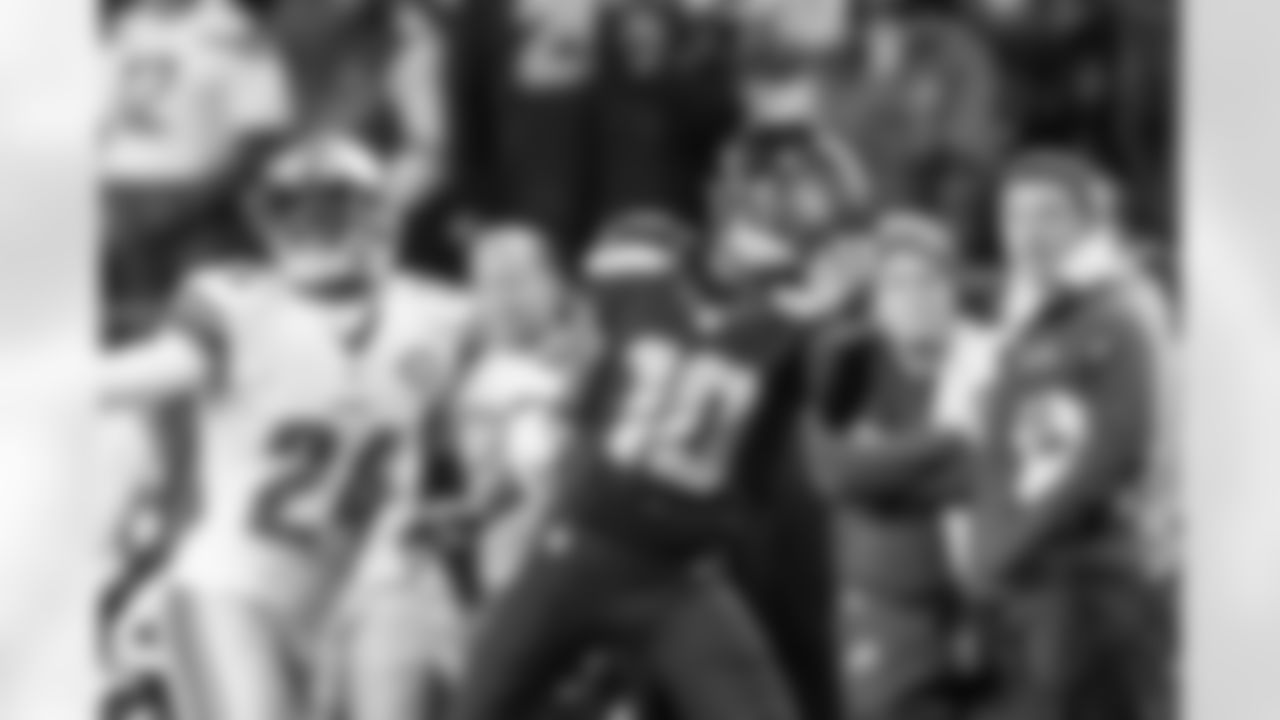 With Detroit's Nevin Lawson holding his right arm, Seattle's Paul Richardson uses his left hand to complete the one-handed catch.