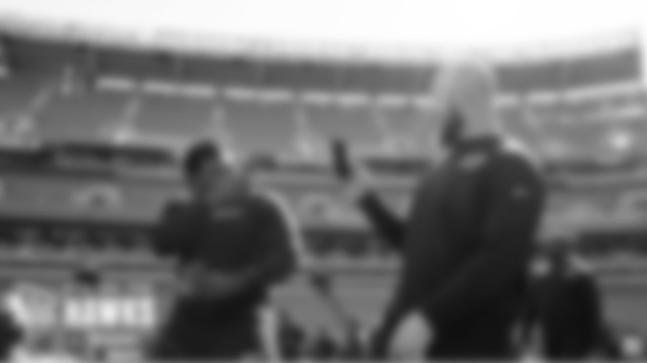 Seahawks offensive linemen D.J. Fluker and Justin Britt have fun with their phones during the team's visit to FirstEnergy Stadium on Saturday.