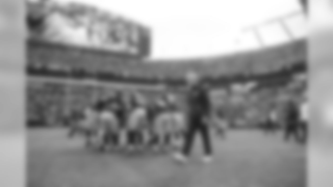 Head coach Pete Carroll paces behind his team as they work on the 11-on-11 portion of pregame warmups in Carolina.