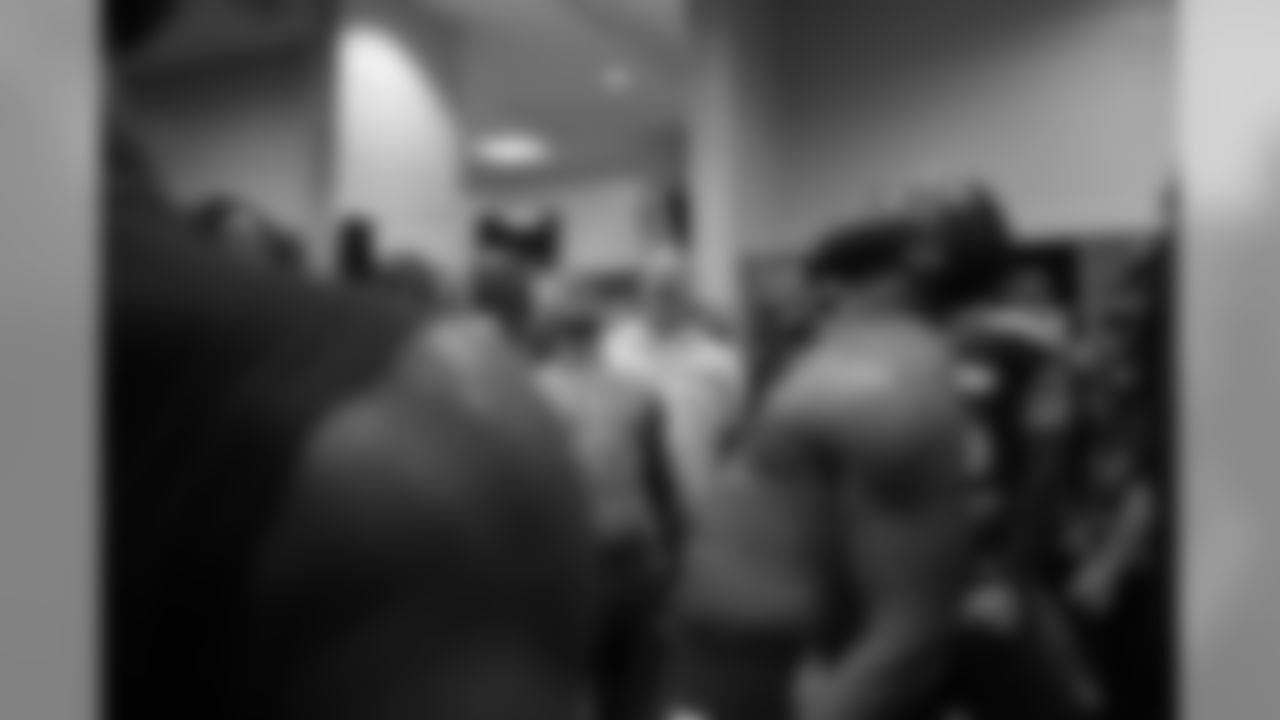 Michael Bennett lets out a yell with teammates at the end of their postgame gathering in the locker room after the win.