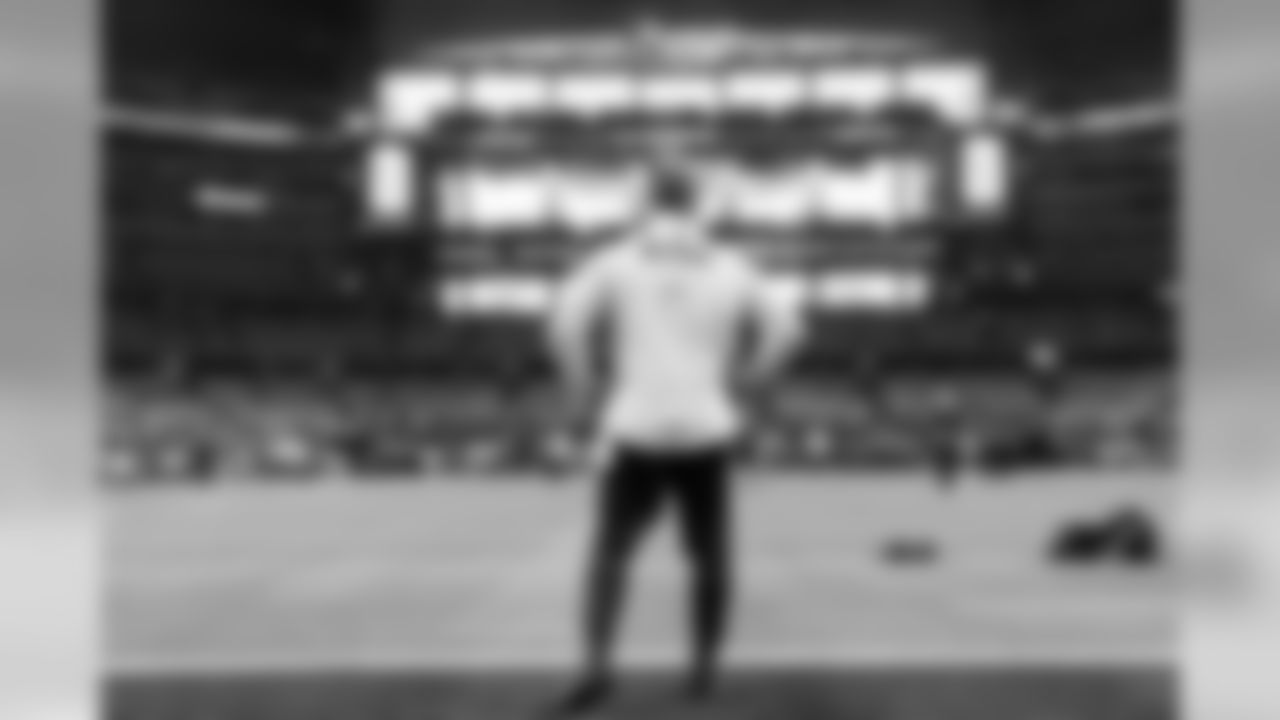 Quarterback Russell Wilson surveys the stadium from the end zone during early pregame warmups.