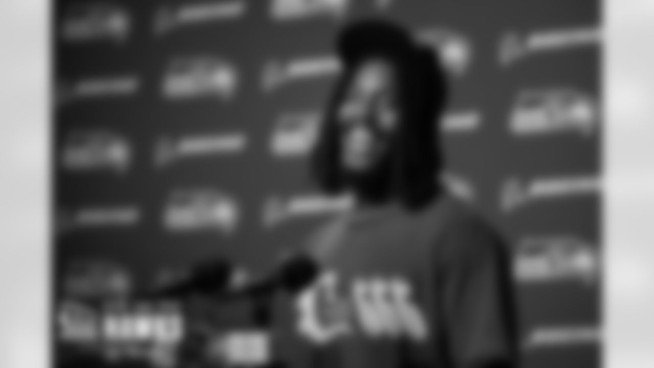 Tyreke Smith laughs at the podium while talking to the media in the post-game press conference.