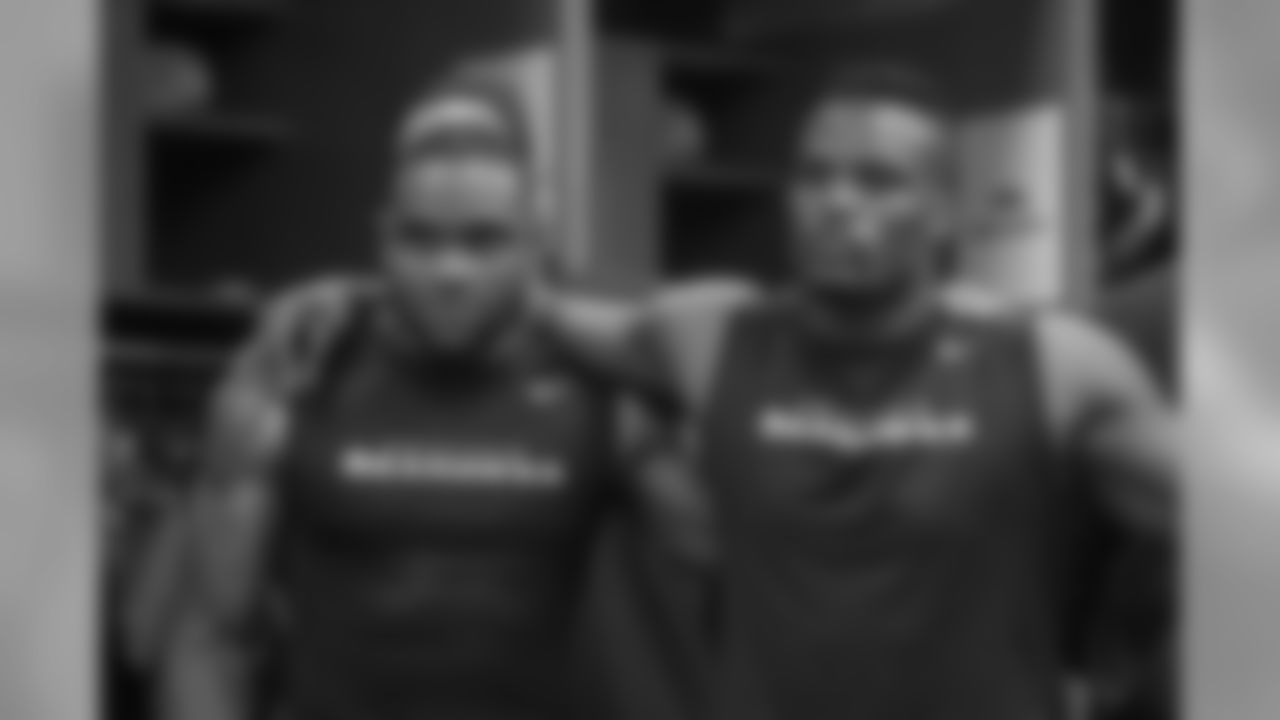 In the locker room after the game, running back Thomas Rawls, left and Fred Jackson listen as head coach Pete Carroll speaks to the team.