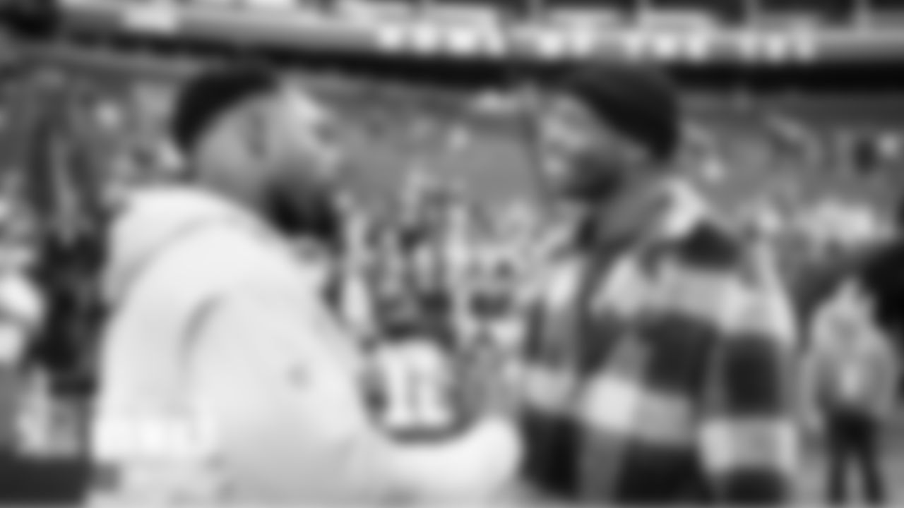 Seahawks newly-signed running back Robert Turbin greets former NFL player Chad ÒOchocincoÓ Johnson on the field before the game.