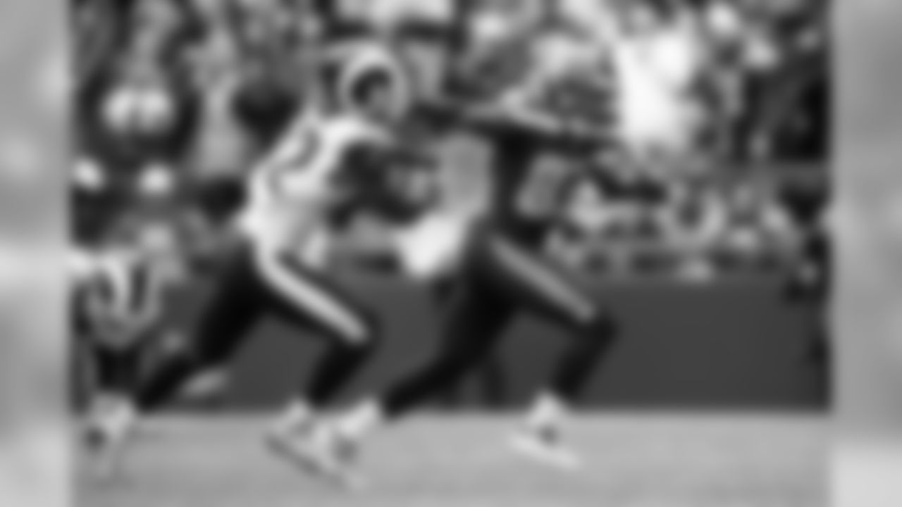 Seattle's David Moore stiff-arms L.A.'s Ramik Wilson in the second quarter.
