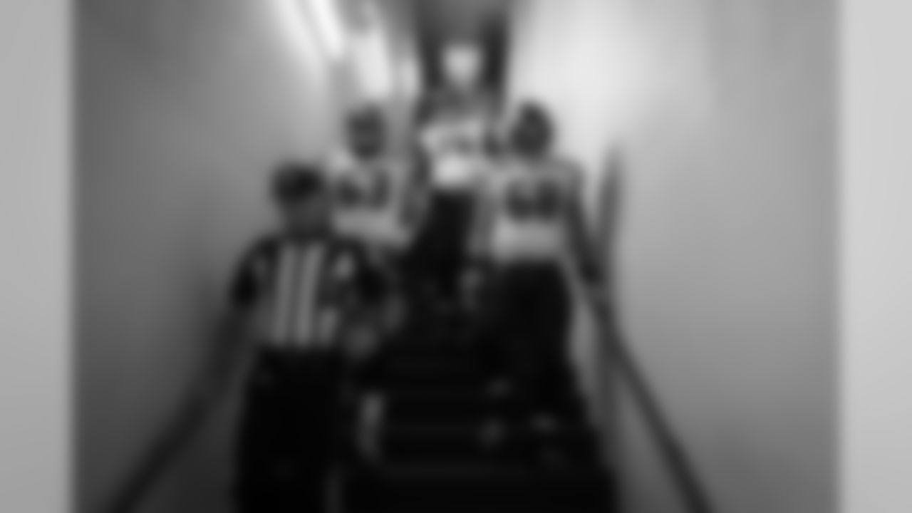 Offensive linemen Mark Glowinski, Germain Ifedi and Justin Britt follow an official down the stairs leading from the locker room to the playing field.