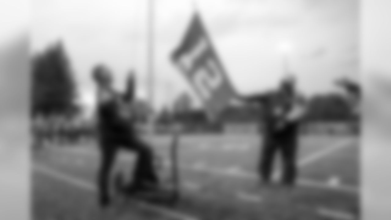 Snoqualmie Valley School District Superintendent Rob Manahan raises the 12 Flag just before kickoff.