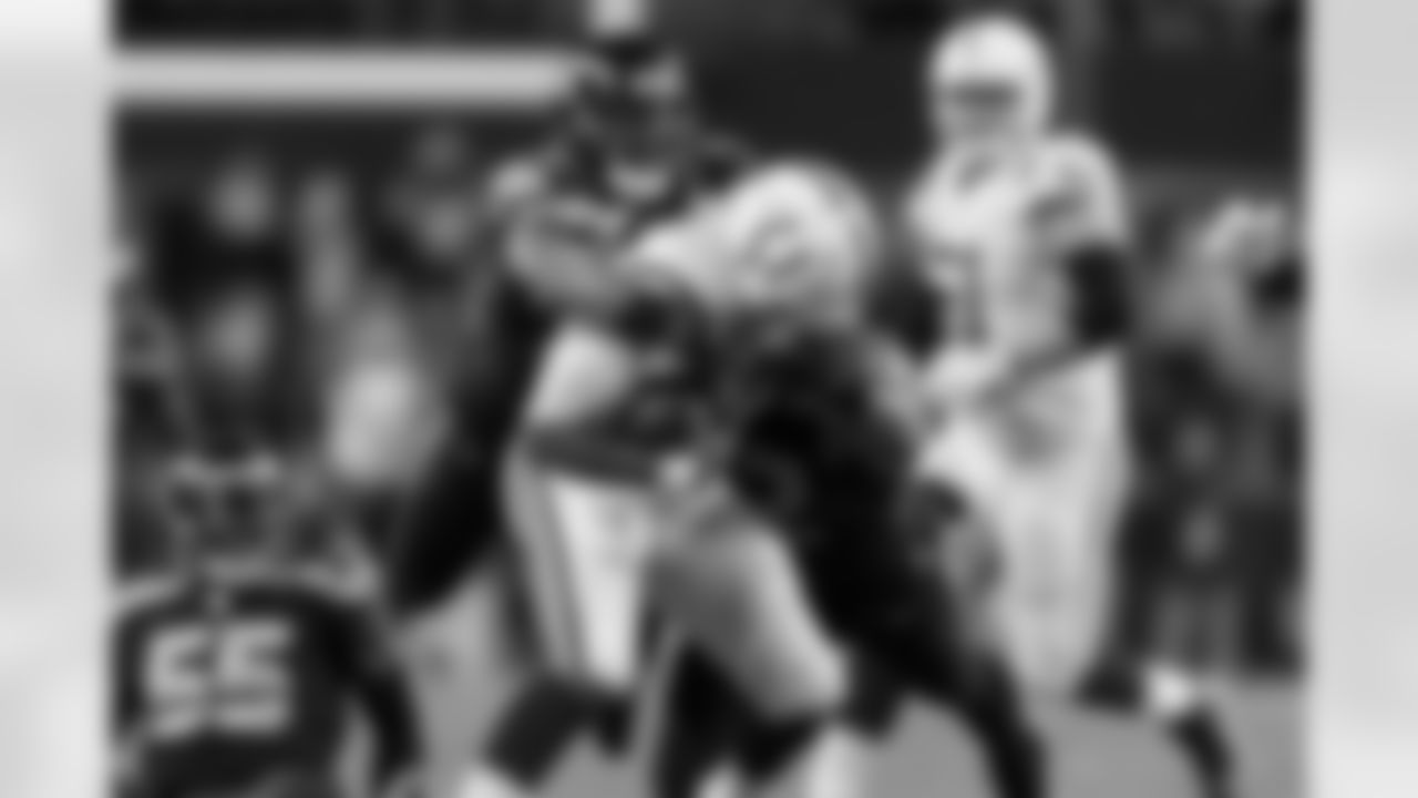 Bobby Wagner and Michael Bennett combine to finish a sack of Colts quarterback Jacoby Brissett.