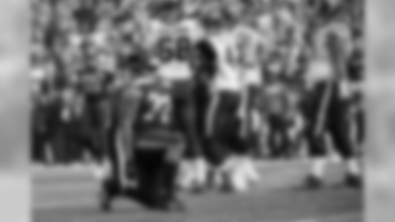Michael Bennett kneels after sacking Houston's Deshaun Watson in the first half.