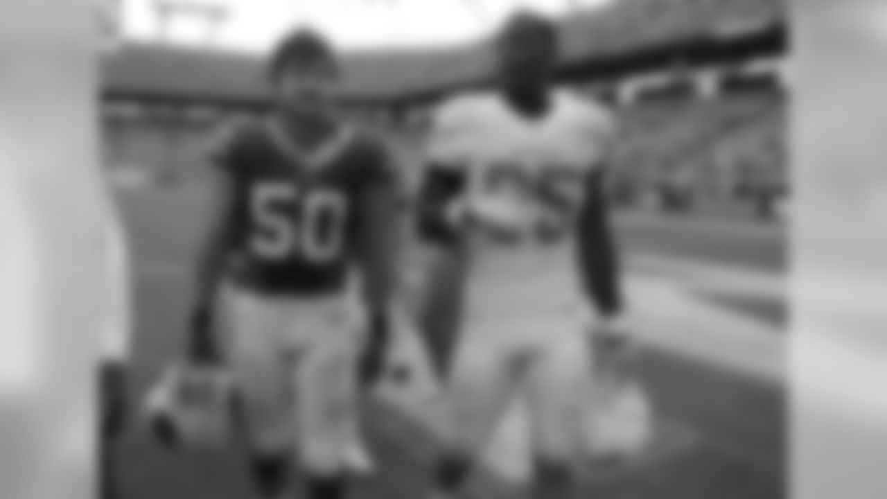 Buffalo Bills middle linebacker Kiko Alonso (50) and Miami Dolphins defensive end Dion Jordan (95) walk off the field after an NFL football game, Sunday, Oct. 20, 2013, in Miami Gardens, Fla. The Bills defeated the Dolphins 23-21. (AP Photo/Lynne Sladky)