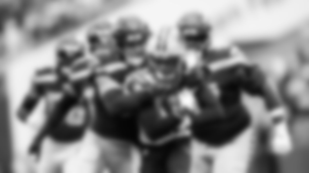 Seahawks linebacker Cody Barton makes a tackle as teammates close in.