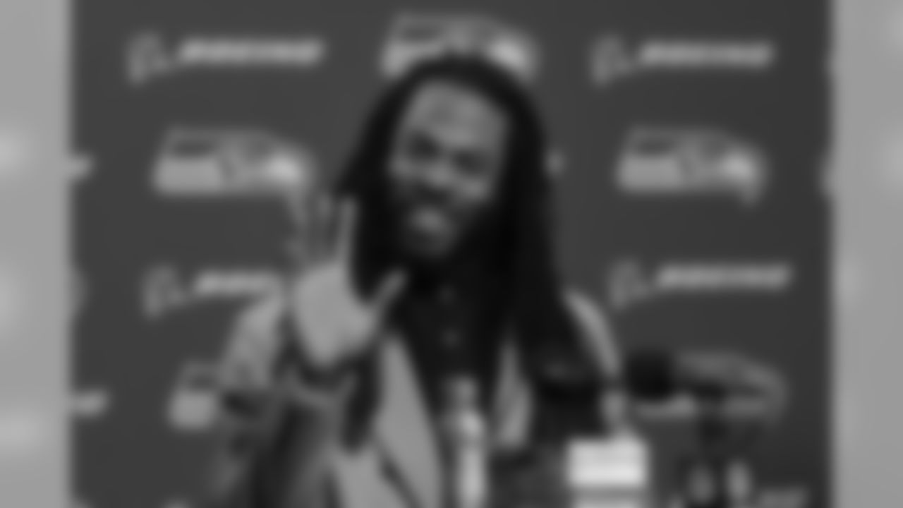 Seahawks cornerback Richard Sherman offers a wave and a smile to the media during his postgame press conference.