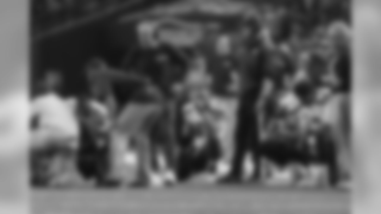 Seahawks personnel wait as the team's medical staff attended to injured cornerback DeShawn Shead.