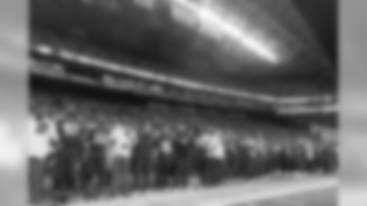 Seahawks players, coaches and staff link arms during the playing of the national anthem.