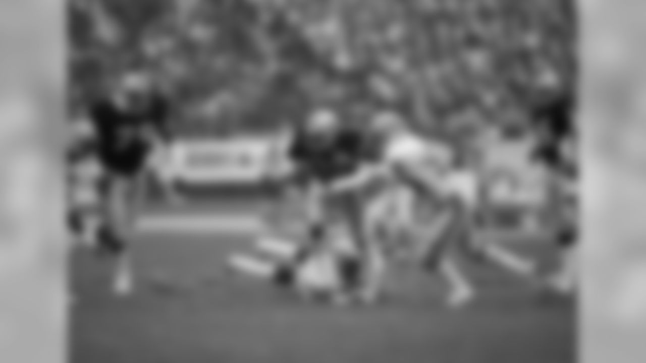 Los Angeles Raiders Marcus Allen (32) takes the ball 12 yards before being stopped by Seattle Seahawks Greg Gaines (56) during action in their AFC Playoff at the Coliseum, Sunday, Jan. 8, 1984, Los Angeles, Calif. (AP Photo)