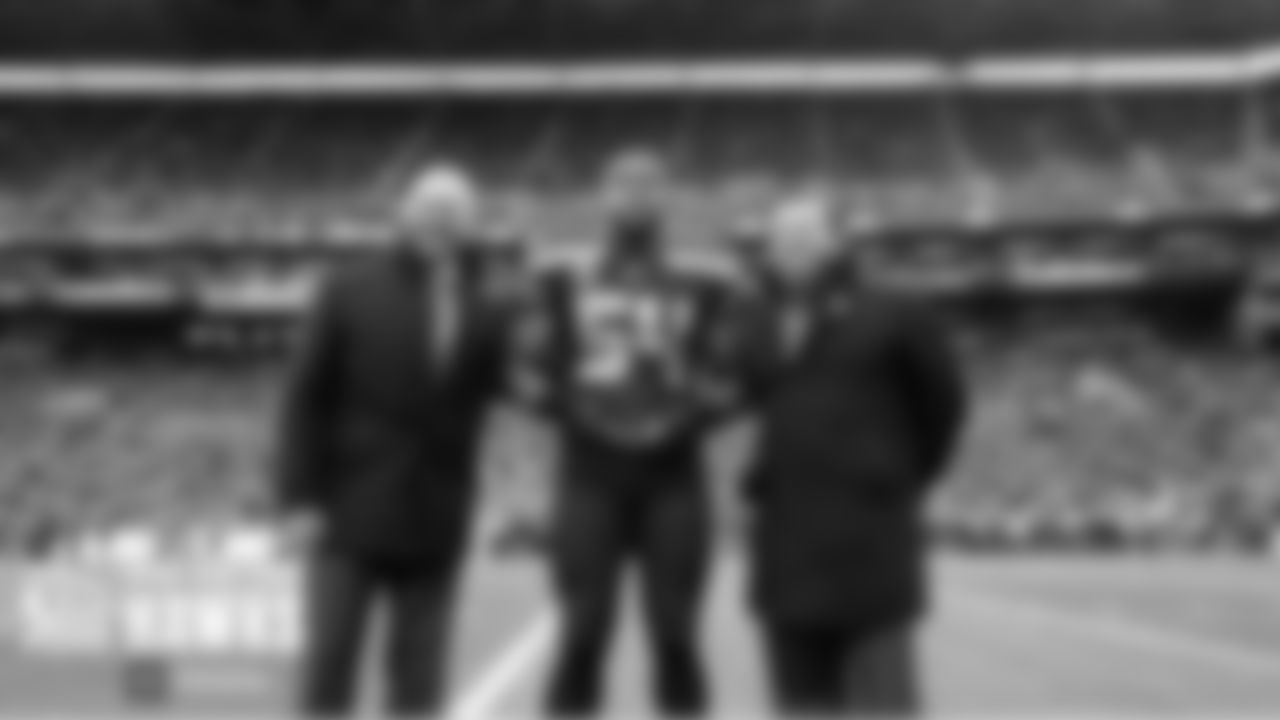 Linebacker and defensive captain Bobby Wagner accepts the Seahawks Man of the Year award from team president Chuck Arnold and general manager John Schneider before the game.