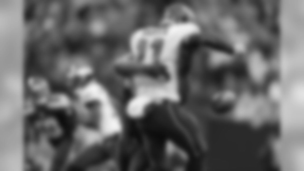Eagles quarterback Carson Went loses the ball as he is hit by Seattle's Cliff Avril.