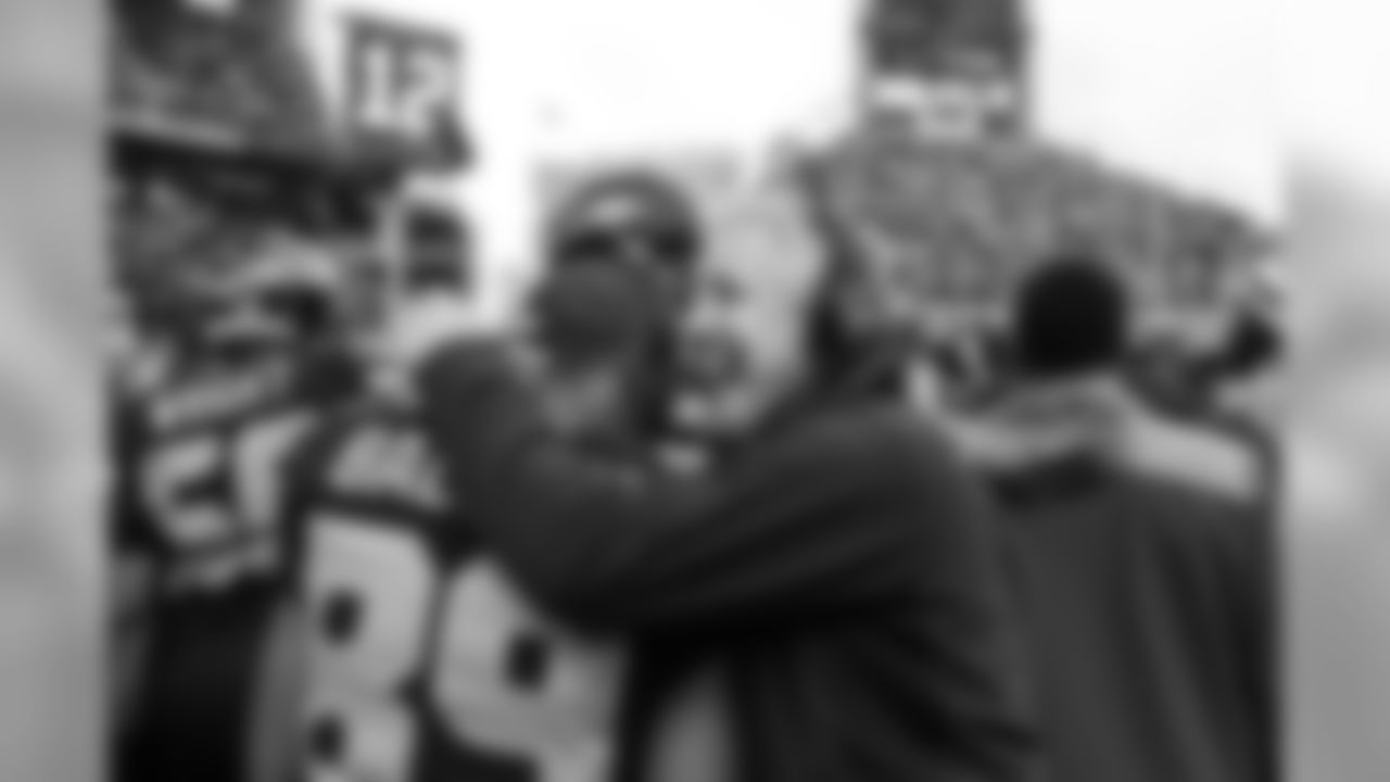 Head coach Pete Carroll hugs Doug Baldwin as the entire team gathers on the Seahawks sideline before kickoff.