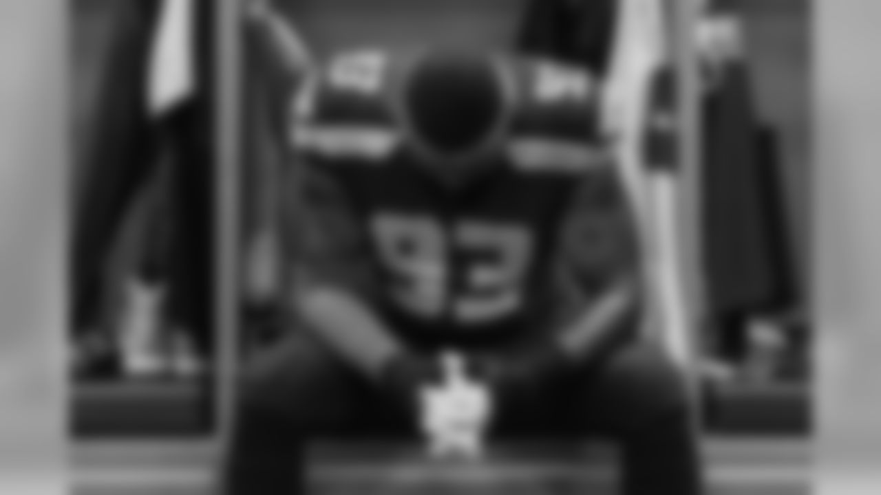 Back in the Seahawks locker room, defensive tackle Tony McDaniel takes a moment to himself. The Seahawks wore pink accessories to honor Breast Cancer Awareness month.