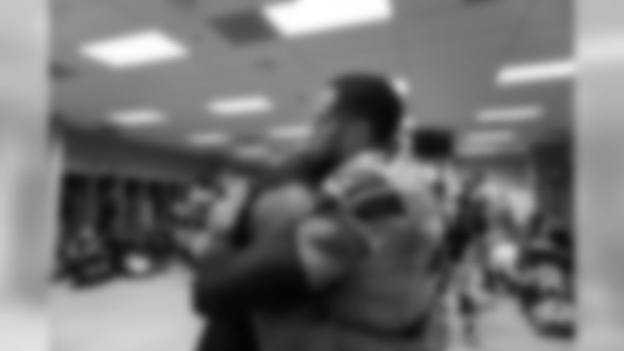 Exhausted Seahawks defensive leaders Michael Bennett and Earl Thomas hug in the locker room after the game. Seattle's defense was on the field for 90 plays.