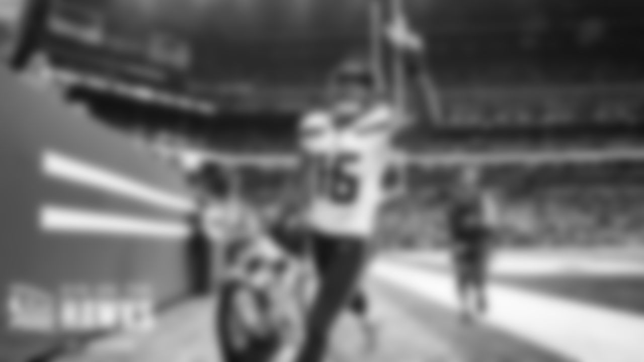 Seattle's Tyler Lockett celebrates his second touchdown of the game with two fingers in the air.