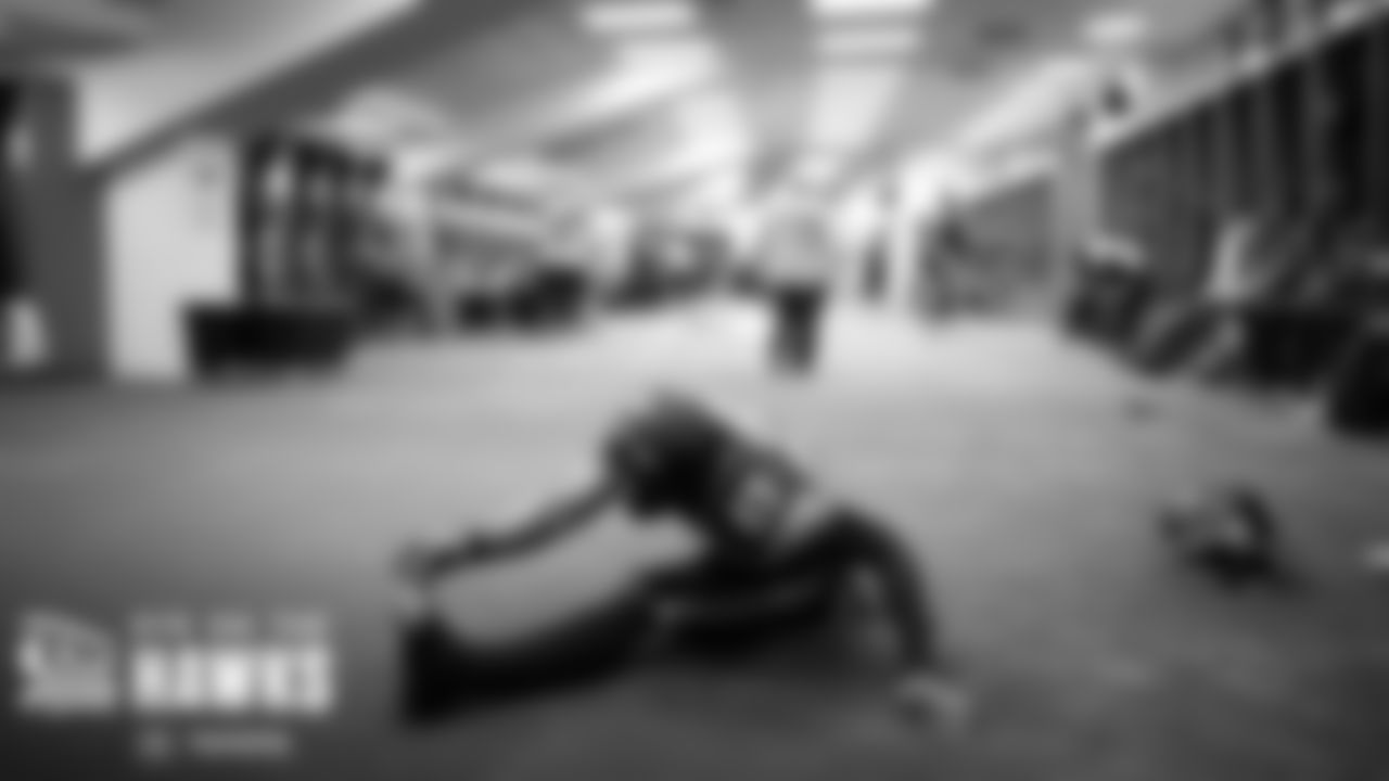 Receiver Dareke Young stretches in the locker room before the team took the field.
