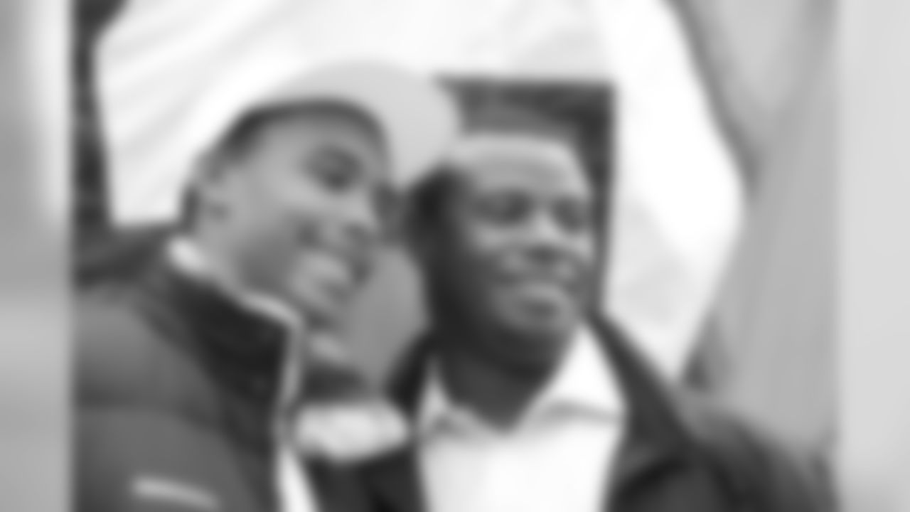 Seattle Mariners' Ken Griffey Jr., right, poses with his son Trey before raising the "12th Man Flag" prior to an NFL football game between the Tennessee Titans and the Seattle Seahawks, Sunday, Jan. 3, 2010. Griffey Jr. likes the offseason moves made by the Seattle Mariners so far and he is optimistically clearing his calendar into November. (AP Photo/John Froschauer)