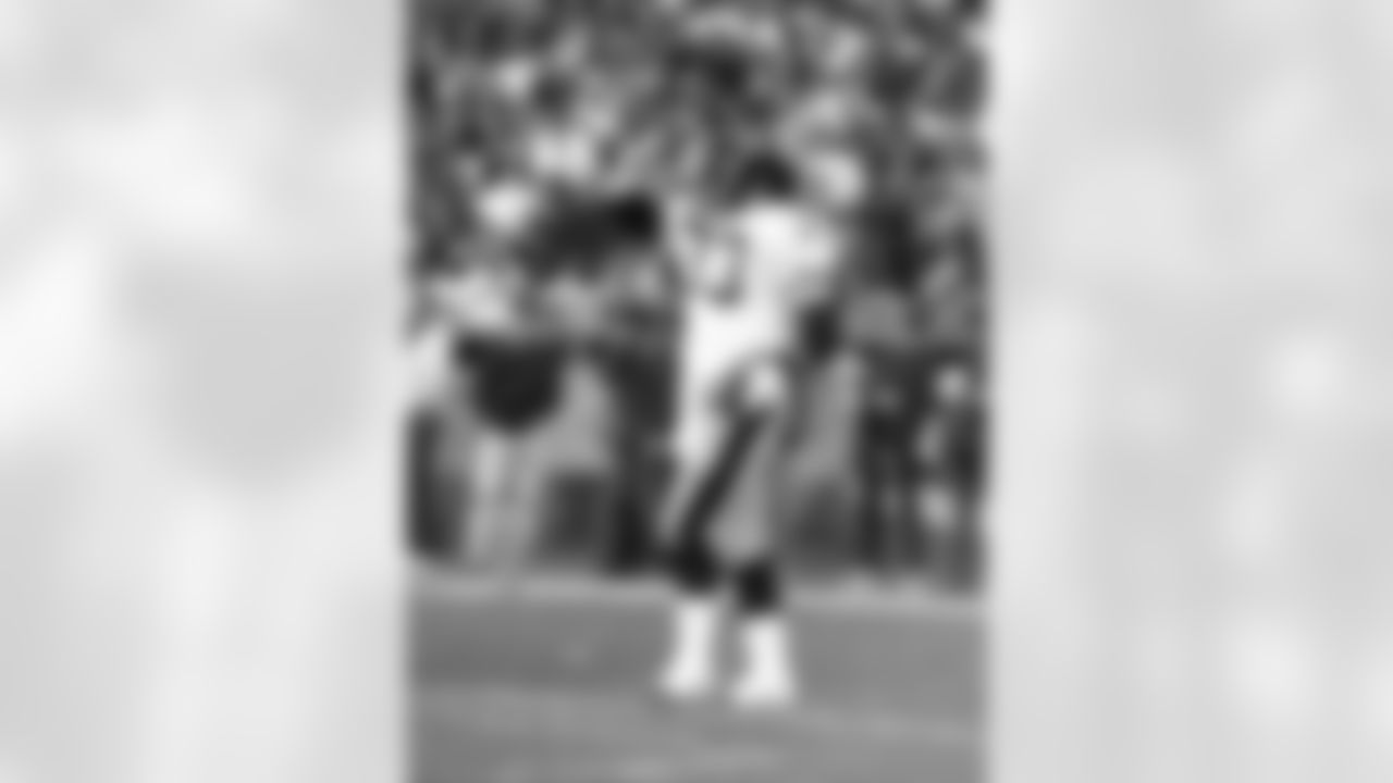 Pittsburgh Steelers running back Merril Hoge (33) holds onto the ball with his index finger in the air after scoring a touchdown during the 1990 NFL AFC Divisional playoff football game against the Denver Broncos on Jan. 7, 1990 in Denver. The Broncos won the game 24-23. (Paul Spinelli via AP)