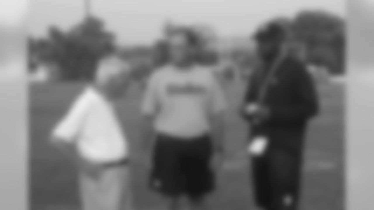 Dan Rooney talks with General Manager Kevin Colbert and Head Coach Mike Tomlin during a 2007 Training Camp at Saint Vincent College.