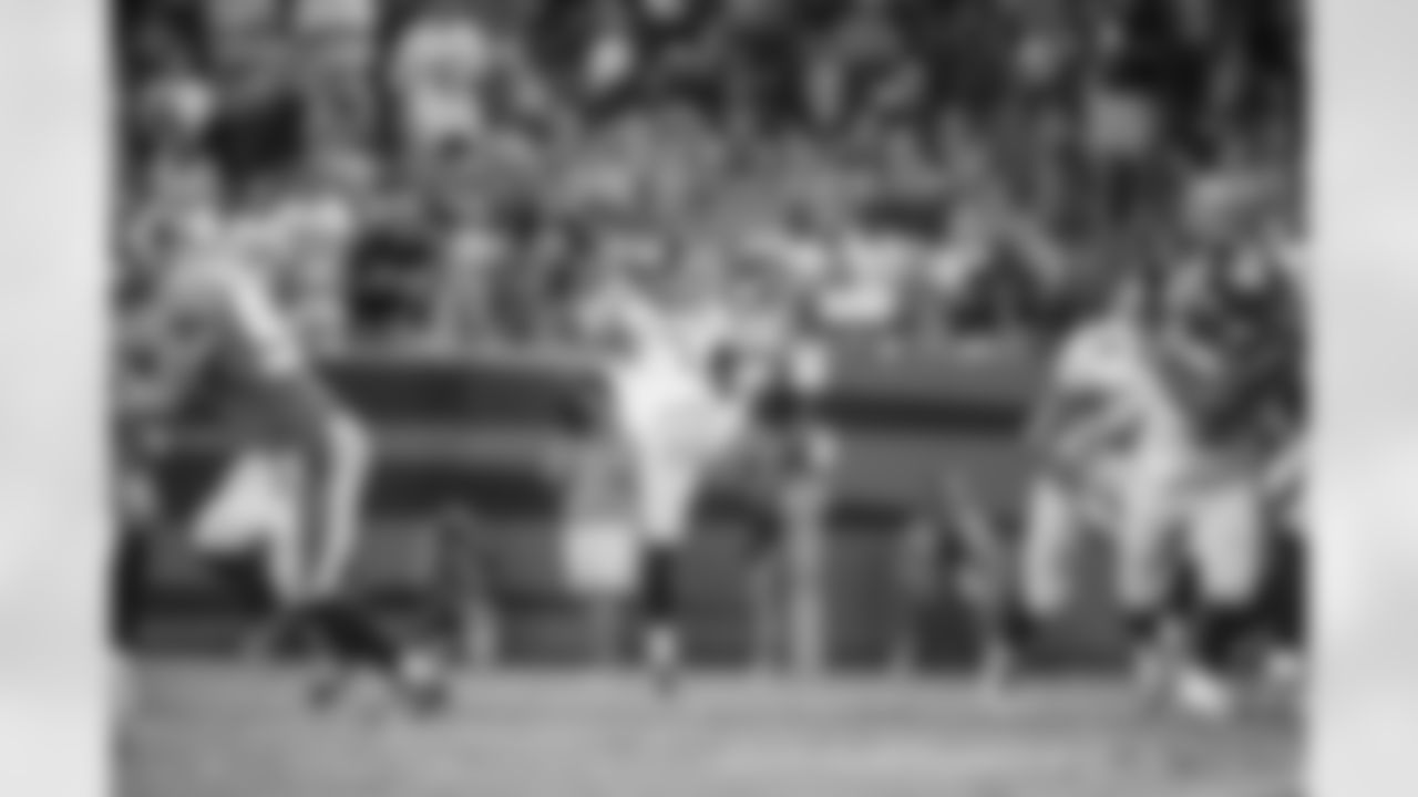 Brad Wing punting against the Carolina Panthers.