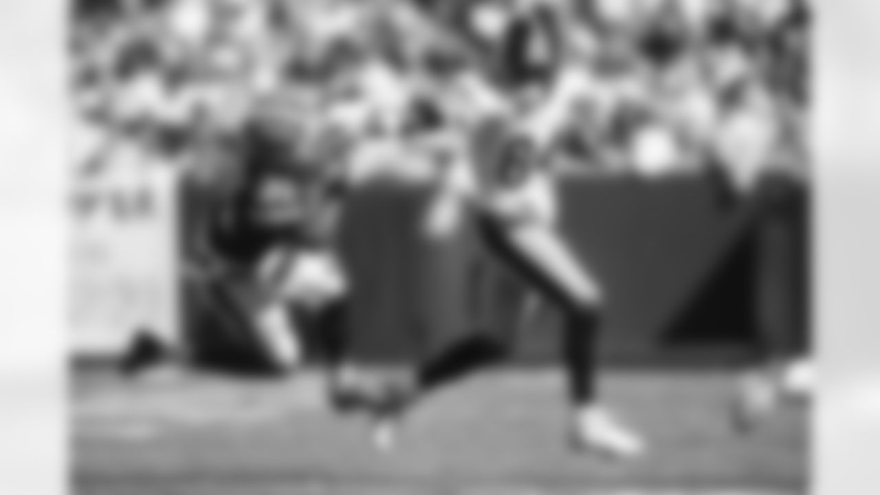 Antonio Brown stiff-arms a Cleveland defender at FirstEnergy Stadium.