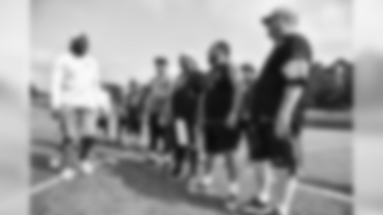 Steelers fans take part in on-field drills during Men's Fantasy Camp.