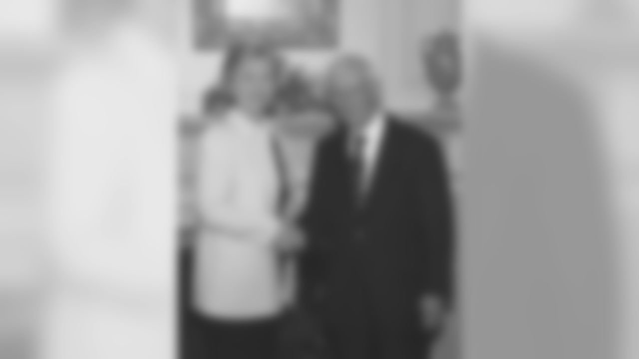 Dan Rooney shakes hands with Secretary of State Hillary Clinton.