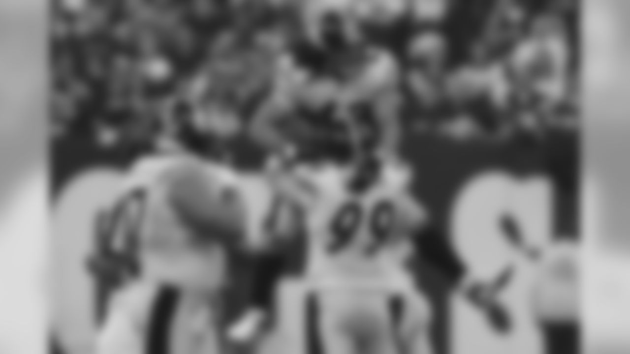 Action photograph of Troy Polamalu celebrating with his teammates after intercepting Peyton Manning during the AFC Divisional Playoff game between the Pittsburgh Steelers and the Indianapolis Colts, where the Steelers defeated the Colts 21-18. The call would later be overturned.