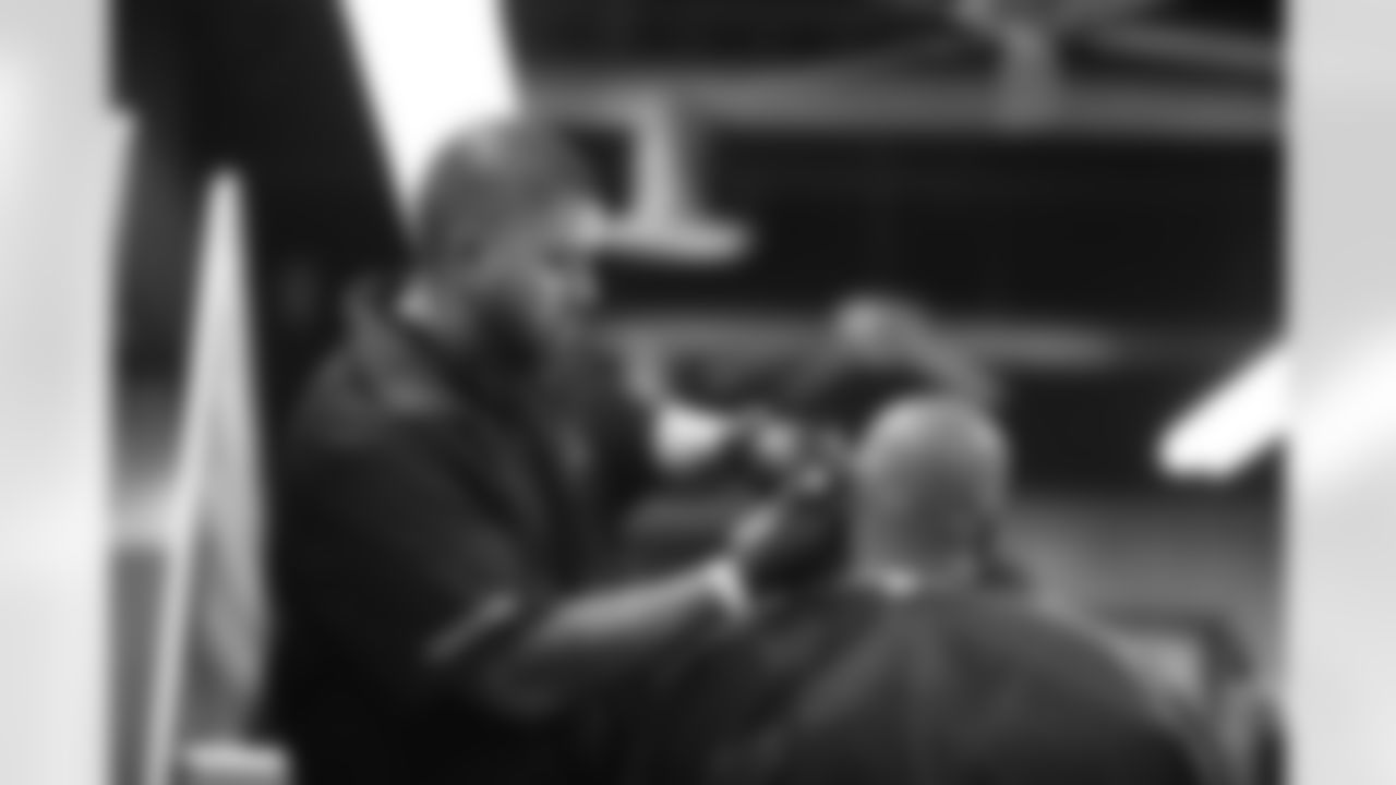 An image from the June 16, 2022 community development event, "Coach's Cuts", at Star of Hope in Houston Texas. Texans' Special Teams Coordinator, Frank Ross, led a haircut program for the Star of Hope residents.