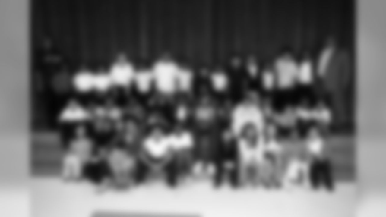 Johnson and the high academic achievers from each grade pose for a group photo.