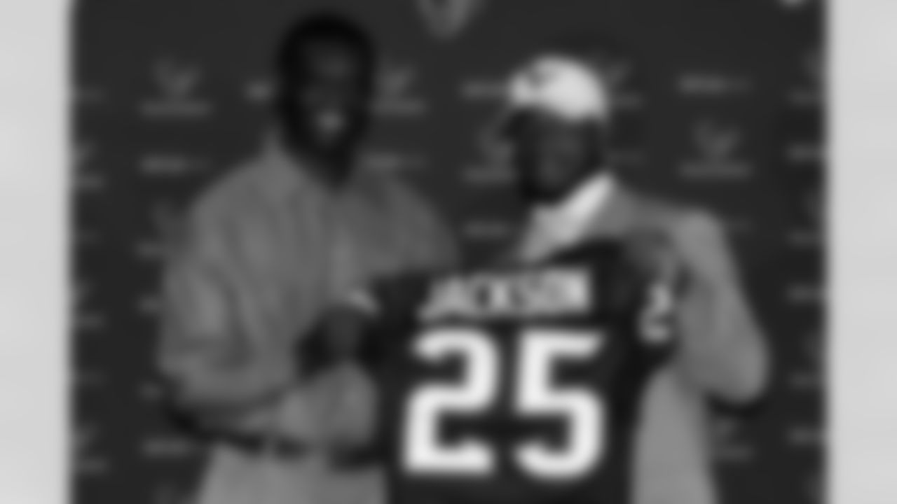 Proudly displaying the new #25 jersey, cornerback Kareem Jackson and defensive coordinator Frank Bush pose for a snapshot.