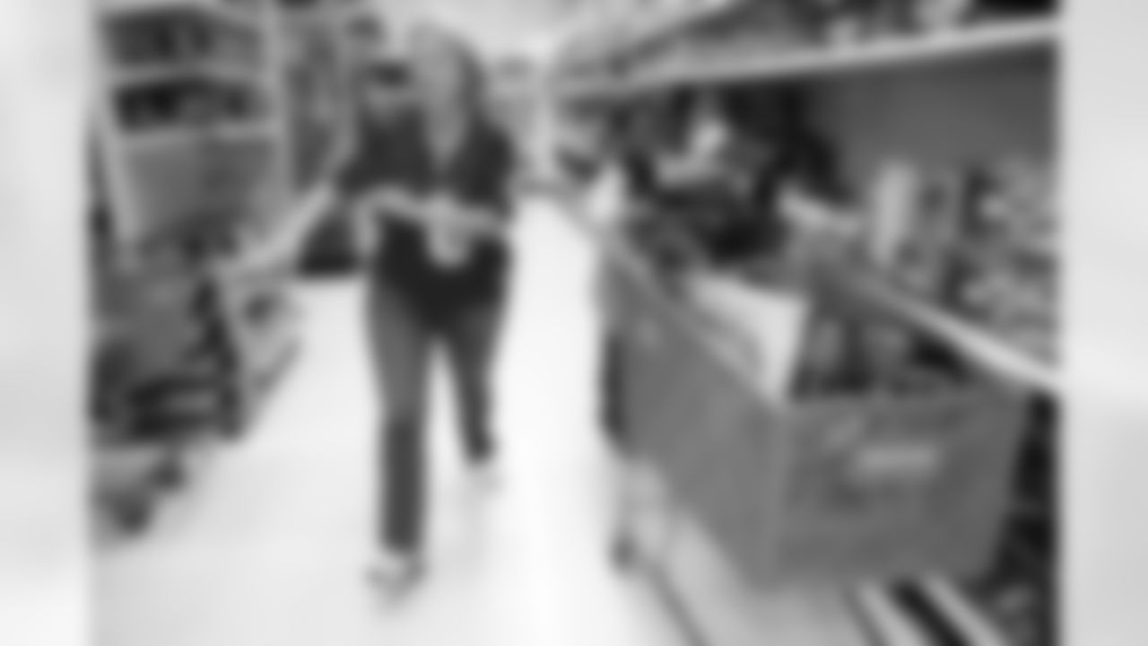 Texans quarterback Matt Schaub's mother, left, struggles to keep up with her young shopper.