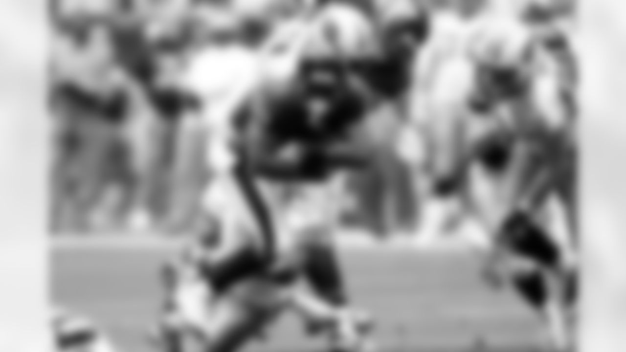 Running back Steve Slaton busts through the Titans' defensive line.
