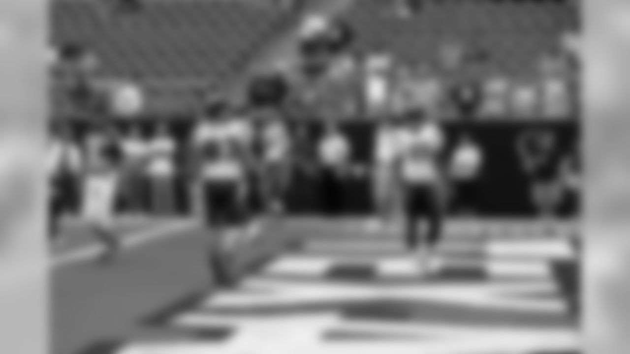 Wide receivers Kevin Walter and Andre' Davis warm up in the end zone.