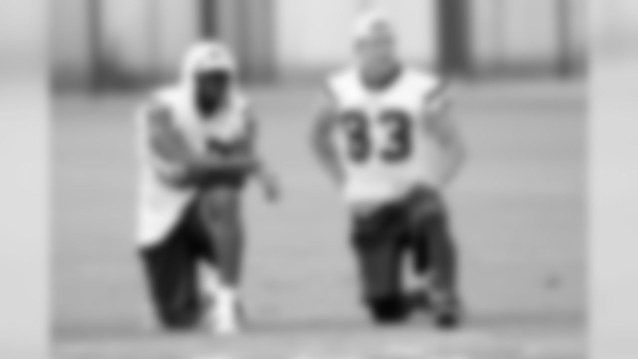 On a sweltering day in Houston, wide receivers Andre Johnson (80) and Kevin Walter (83) check out the action on the field during a break in OTA number seven.