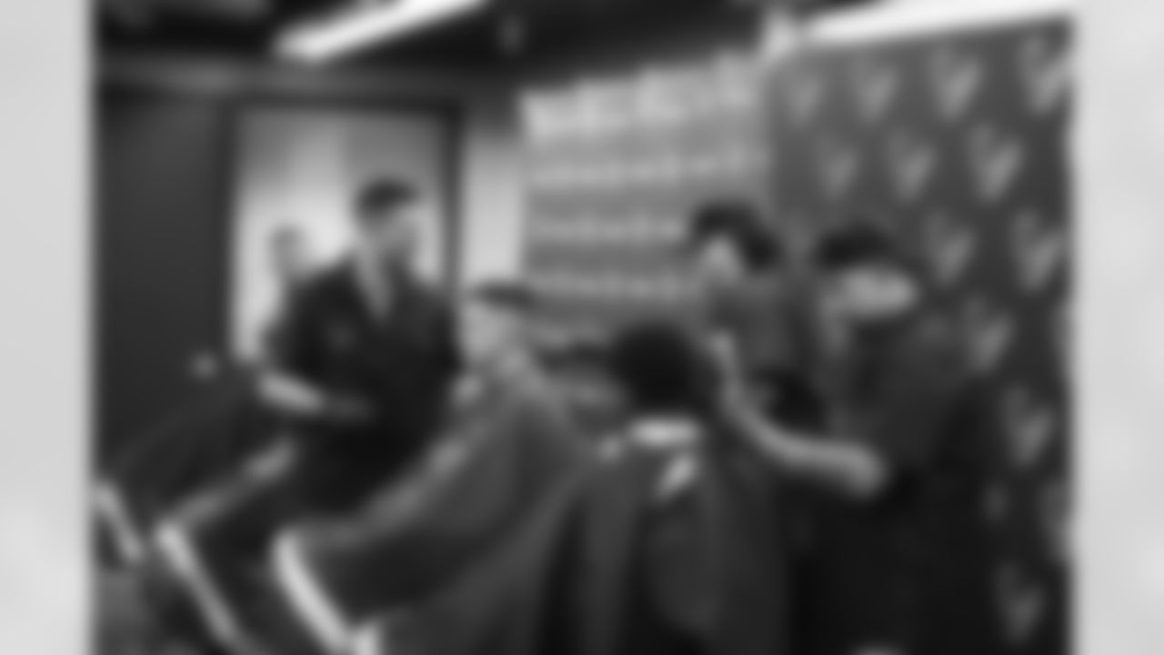 An image from the June 16, 2022 community development event, "Coach's Cuts", at Star of Hope in Houston Texas. Texans' Special Teams Coordinator, Frank Ross, led a haircut program for the Star of Hope residents.
