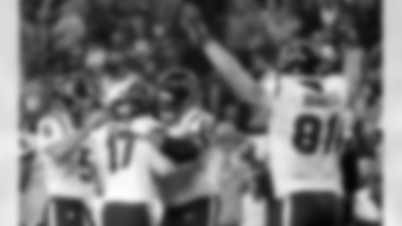 Houston Texans kicker Shayne Graham (17) is congratulated by Donnie Jones (5) and Ryan Harris (68) after kicking the game-winning field goal in overtime of an NFL football game against the Detroit Lions at Ford Field in Detroit, Thursday, Nov. 22, 2012. The Texans won 34-31. At right celebrating is Texans' Owen Daniels. (AP Photo/Rick Osentoski)