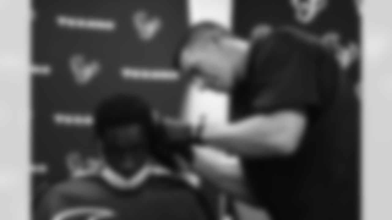 An image from the June 16, 2022 community development event, "Coach's Cuts", at Star of Hope in Houston Texas. Texans' Special Teams Coordinator, Frank Ross, led a haircut program for the Star of Hope residents.