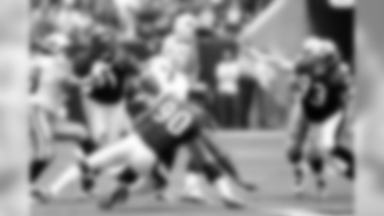 Defensive end Mario Williams, defensive end Tim Bulman and defensive tackle Amobi Okoye put pressure on quarterback Kerry Collins.