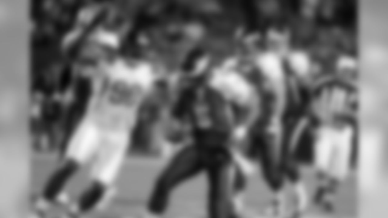 Defensive end Mario Williams closes in on Donovan McNabb of the Eagles for a sack.
