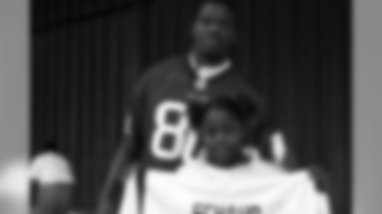 Johnson smiles with a young student who won an autographed Matt Schaub jersey.