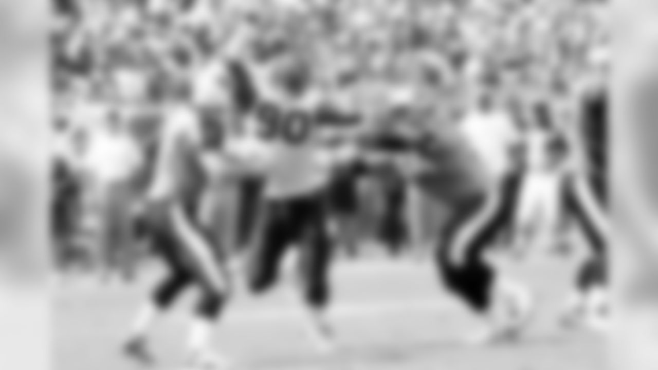 Defensive end Mario Williams puts pressure on quarterback Kerry Collins.