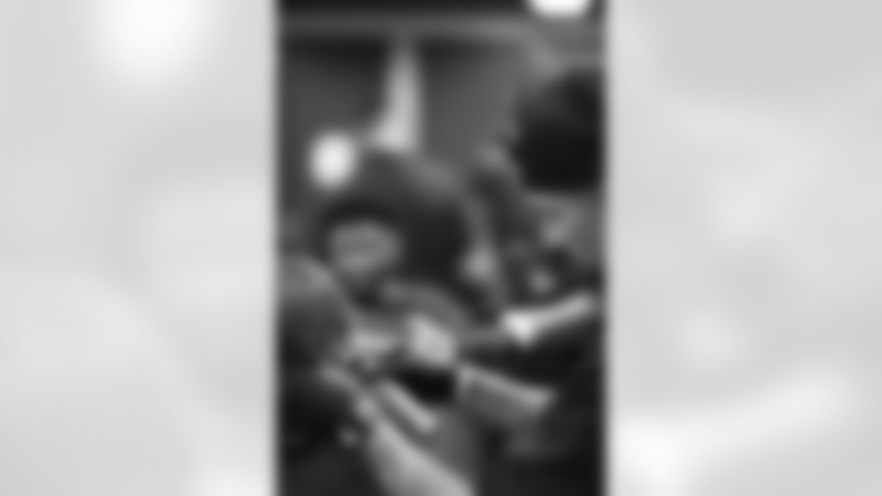 An image from the June 16, 2022 community development event, "Coach's Cuts", at Star of Hope in Houston Texas. Texans' Special Teams Coordinator, Frank Ross, led a haircut program for the Star of Hope residents.