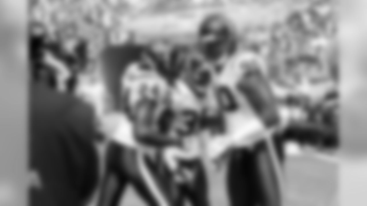 The defense celebrates Jacques Reeves' interception.